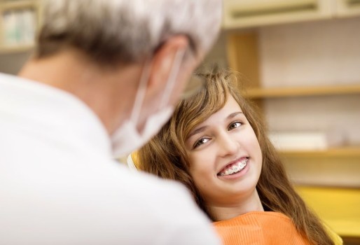 Young Girl Smiling in Orthodontists Office chair
