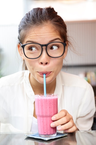 Young lady drinking a smoothie