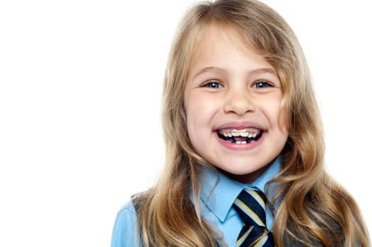 young school girl smiling with braces