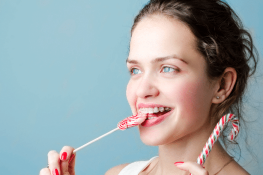 Girl in braces eating hard candy