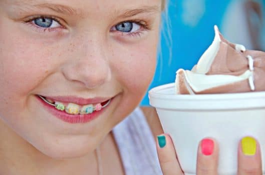 Young girl with braces eating ice cream