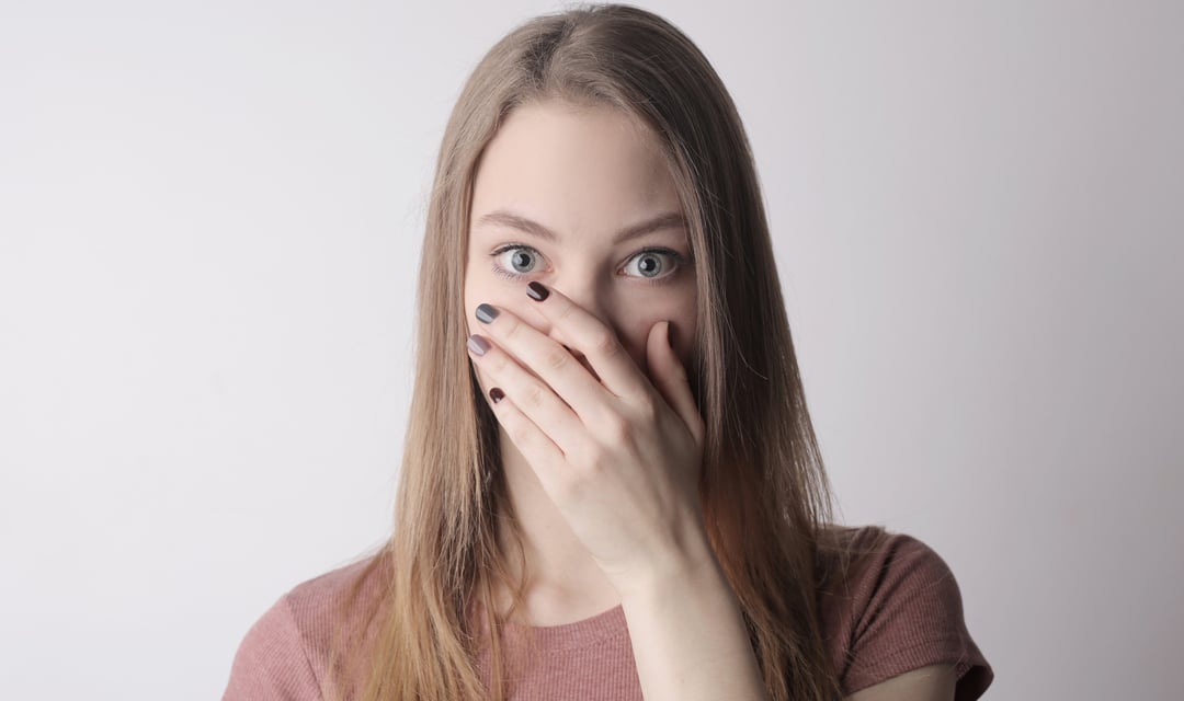Woman Covering Mouth with Hand